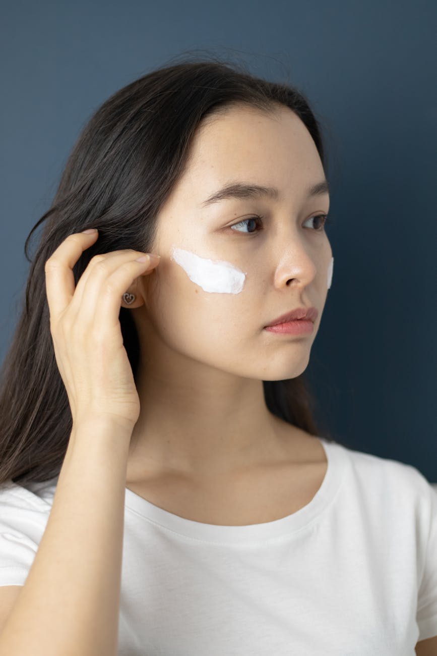 a woman with a skin care product on her face